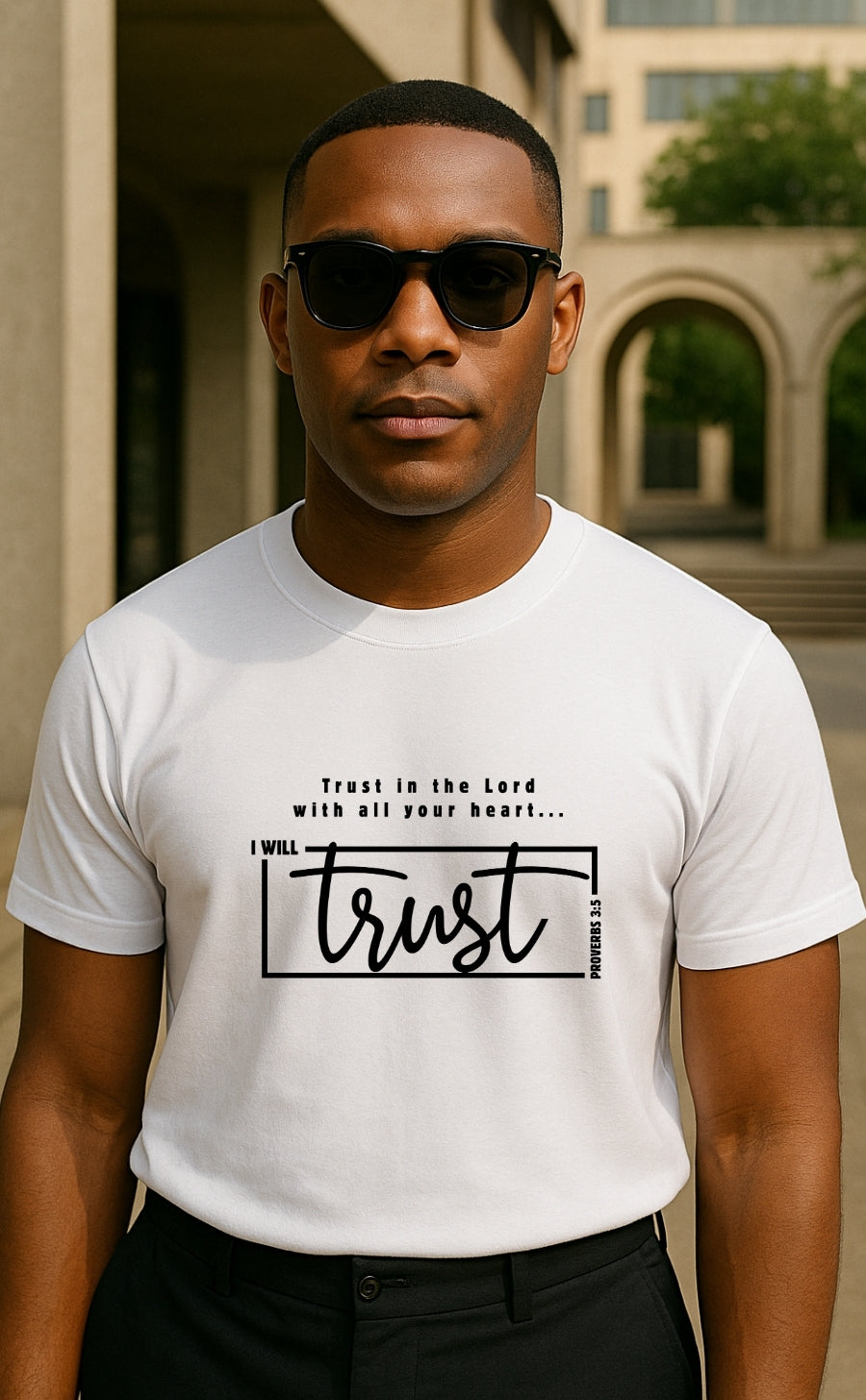 Man wearing white t-shirt from VerseWear by L’authority with Proverbs 3:5 – 'I Will Trust in the Lord with all your heart' – modern Christian streetwear photographed in urban setting