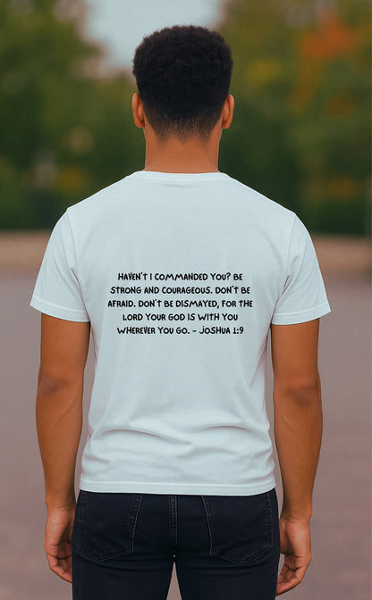A young Black man seen from the back, wearing a white Christian t-shirt by VerseWear by L'authority. The shirt features the full Bible verse Joshua 1:9 in bold black text: “Haven’t I commanded you? Be strong and courageous…,” delivering a powerful message of faith, strength, and divine assurance.