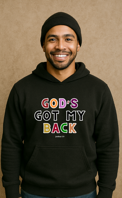 Smiling man wearing black Christian hoodie from VerseWear by L'authority with bold multicolour text 'God’s Got My Back – Joshua 1:9' – faith-based streetwear