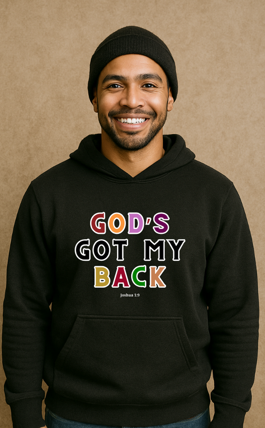 Smiling man wearing black Christian hoodie from VerseWear by L'authority with bold multicolour text 'God’s Got My Back – Joshua 1:9' – faith-based streetwear